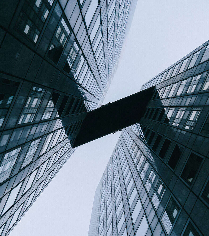 A view of two skyscrapers from below.